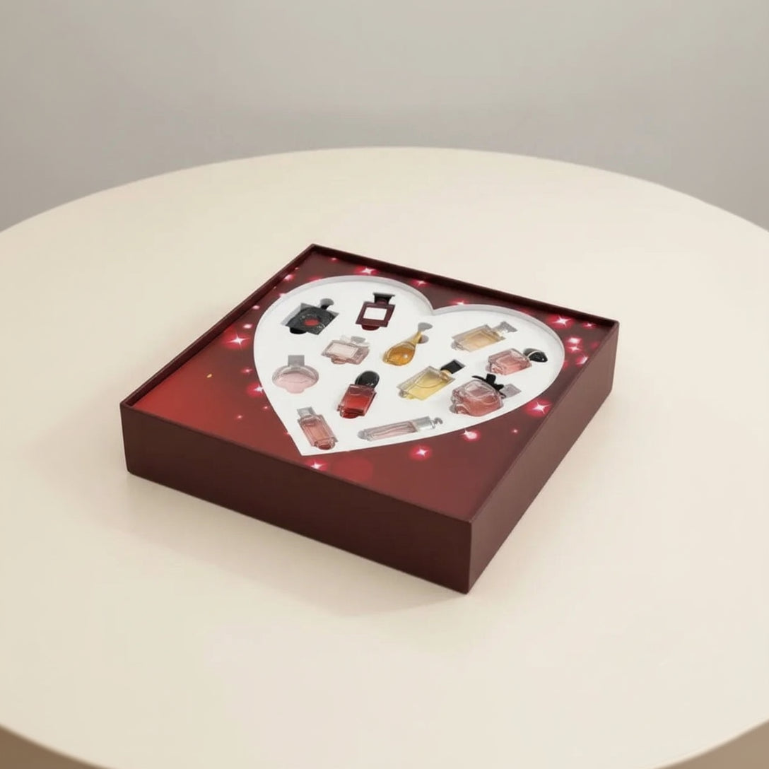 Heart‑shaped designer miniature perfume gift set with 11 mini bottles in a red square box on beige background – Aura Luxe UAE